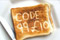 a slice of toast showing a text code